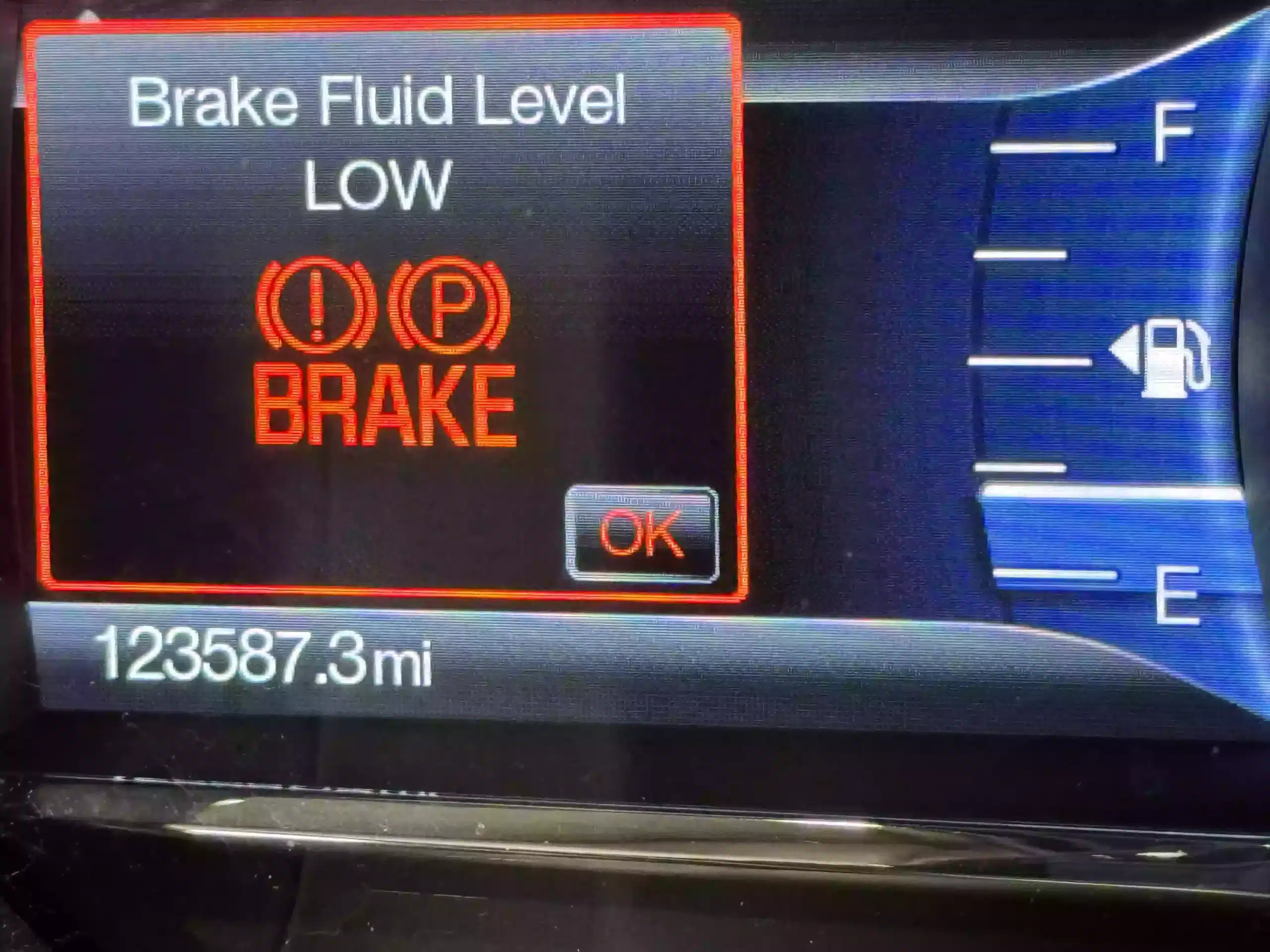 Brake fluid level warning light illuminated on a car dashboard, indicating the need for a brake fluid flush. Trust NexGen Automotive in Sheboygan, WI for top-tier service and regular brake fluid maintenance.