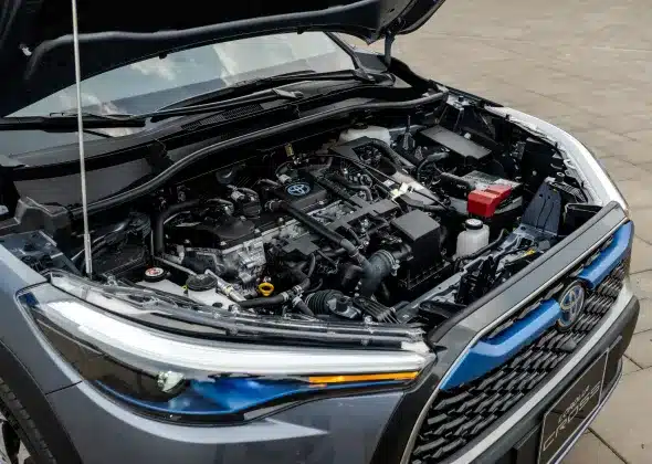 A close-up view of the engine bay of a Toyota vehicle with the hood open, showcasing the various components.