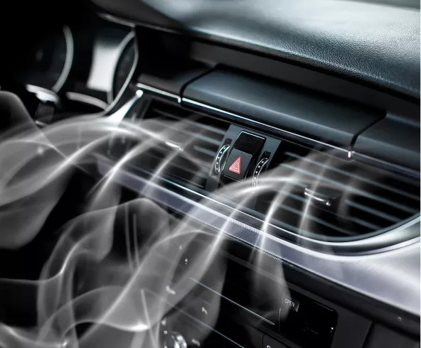 Air conditioning system inside a car blowing cold air through the vents, highlighting the importance of a well-functioning auto A/C system.