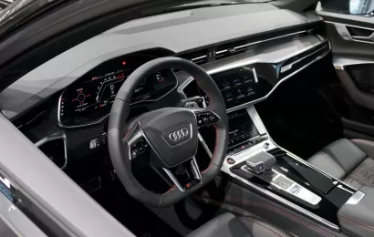 The luxurious interior of an Audi, showcasing the advanced dashboard, steering wheel, and center console.