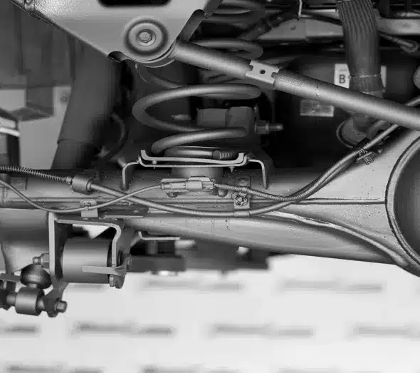 Close-up view of a car's suspension system, highlighting the springs, shock absorbers, and other key components.