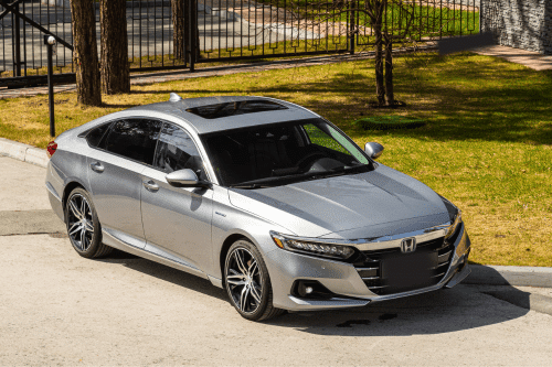 Image of newer silver honda accord with sunroof parked outside during the daytime.