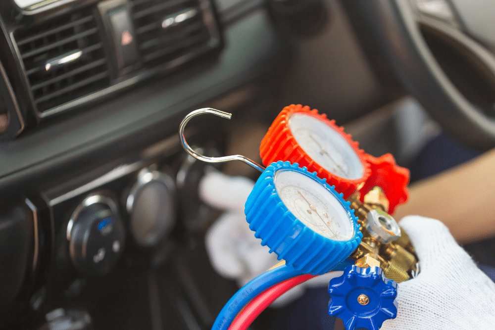 a/c maintenance, auto repair in Sheboygan, WI at NexGen Automotive. Image of A/C manifold gauges held inside a car, preparing for system testing.