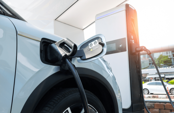 electric vehicle maintenance, auto repair in Sheboygan, WI at NexGen Automotive. Electric vehicle plugged into a charging station.